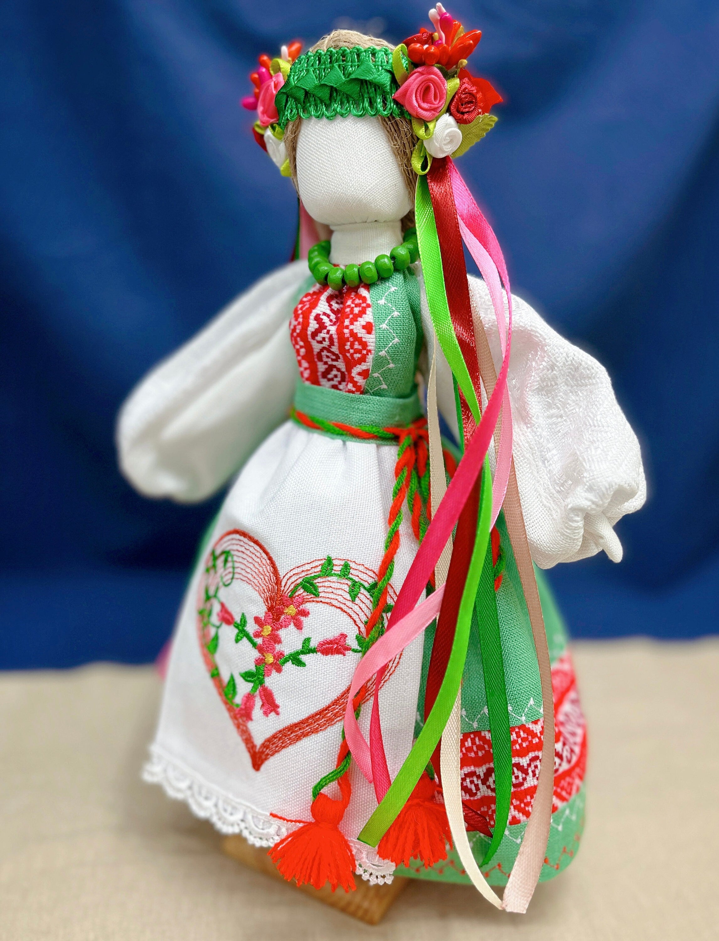 Handmade Ukrainian Motanka doll, "Spring Bride," with colorful folk dress and floral headpiece, symbolizing protection and prosperity.