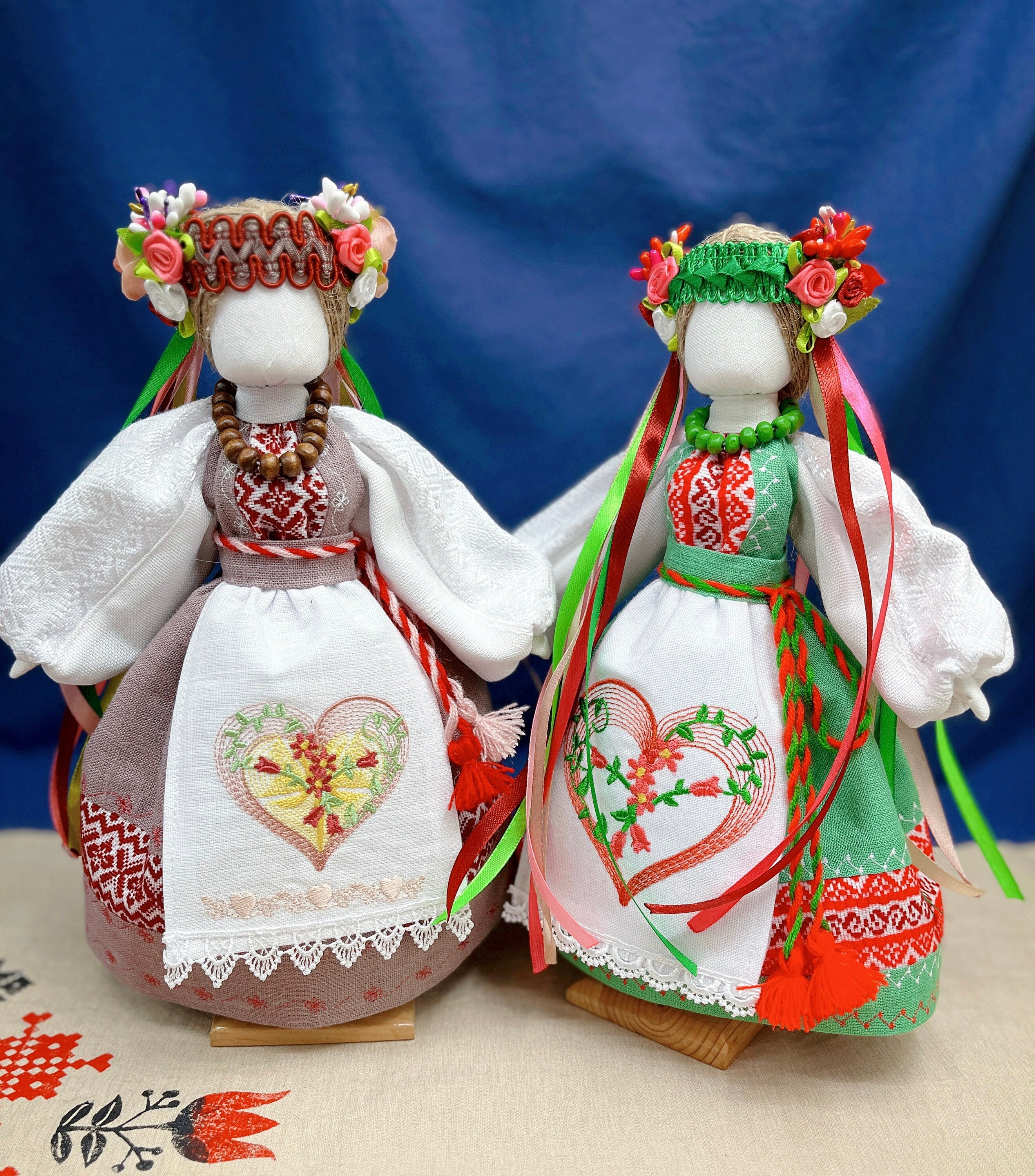 Handmade Ukrainian Motanka dolls, traditional Slavic talismans, featuring vibrant dresses and floral headpieces for home protection.