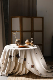 Handmade Ukrainian embroidered tablecloth with ethnic designs on dining table, 300x150 cm, cultural decor for home, gift option.