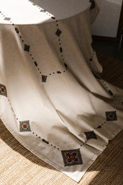 Handmade Ukrainian embroidered tablecloth with ethnic designs, 300x150 cm, on a dining table, showcasing traditional linen decor.