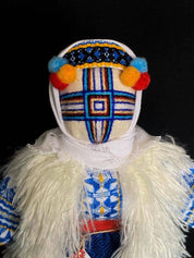 Handmade Ukrainian Motanka Doll 'Christmas' on a wooden stand, decorated with traditional festive attire and vibrant colors.