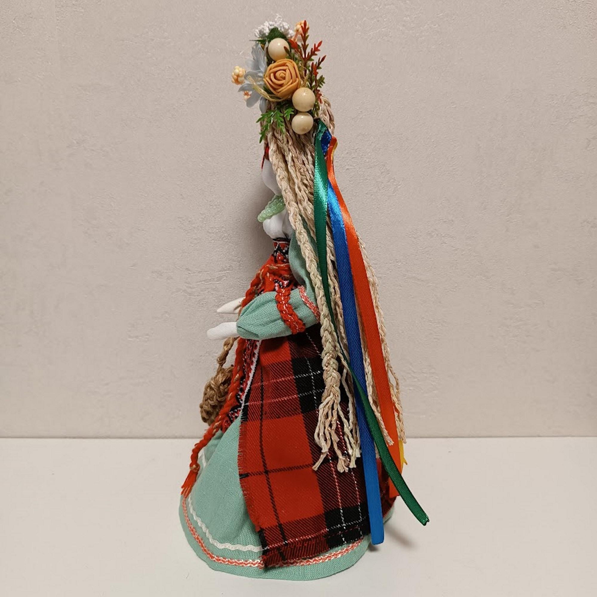 Handmade Ukrainian Motanka Doll with colorful dress and flower headdress, side view, 28 cm, unique cultural decor and gift.