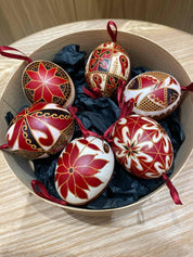 Set of 6 handmade Ukrainian Pysanky eggs, featuring traditional folk art designs in red and black, perfect as a unique Easter or Christmas gift.