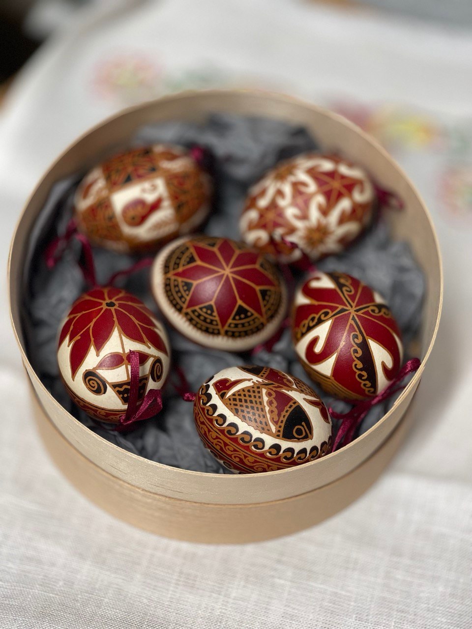 Set of 6 handmade Ukrainian Pysanky eggs with traditional patterns in gift box, perfect for Easter or Christmas gifting.