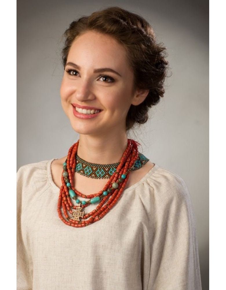 Woman wearing handmade Ukrainian Sylyanka necklace with ceramic and turquoise beads, showcasing traditional ethnic folk jewelry.