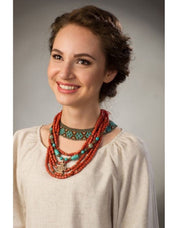 Woman wearing handmade Ukrainian Sylyanka necklace with ceramic and turquoise beads, showcasing traditional ethnic folk jewelry.