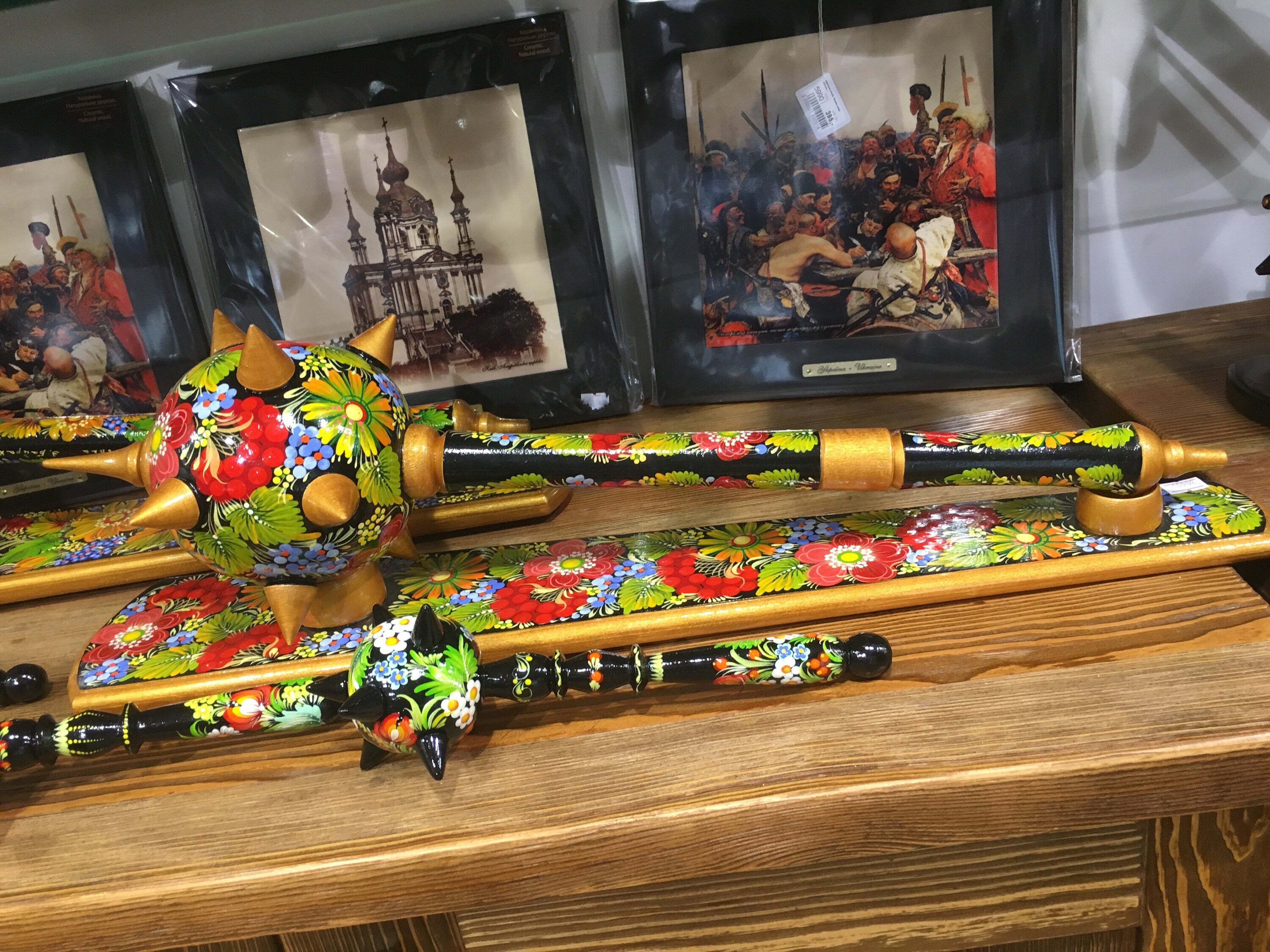 Colorful handmade wooden Ukrainian bulava mace with floral designs, traditional symbol of leadership and craftsmanship.