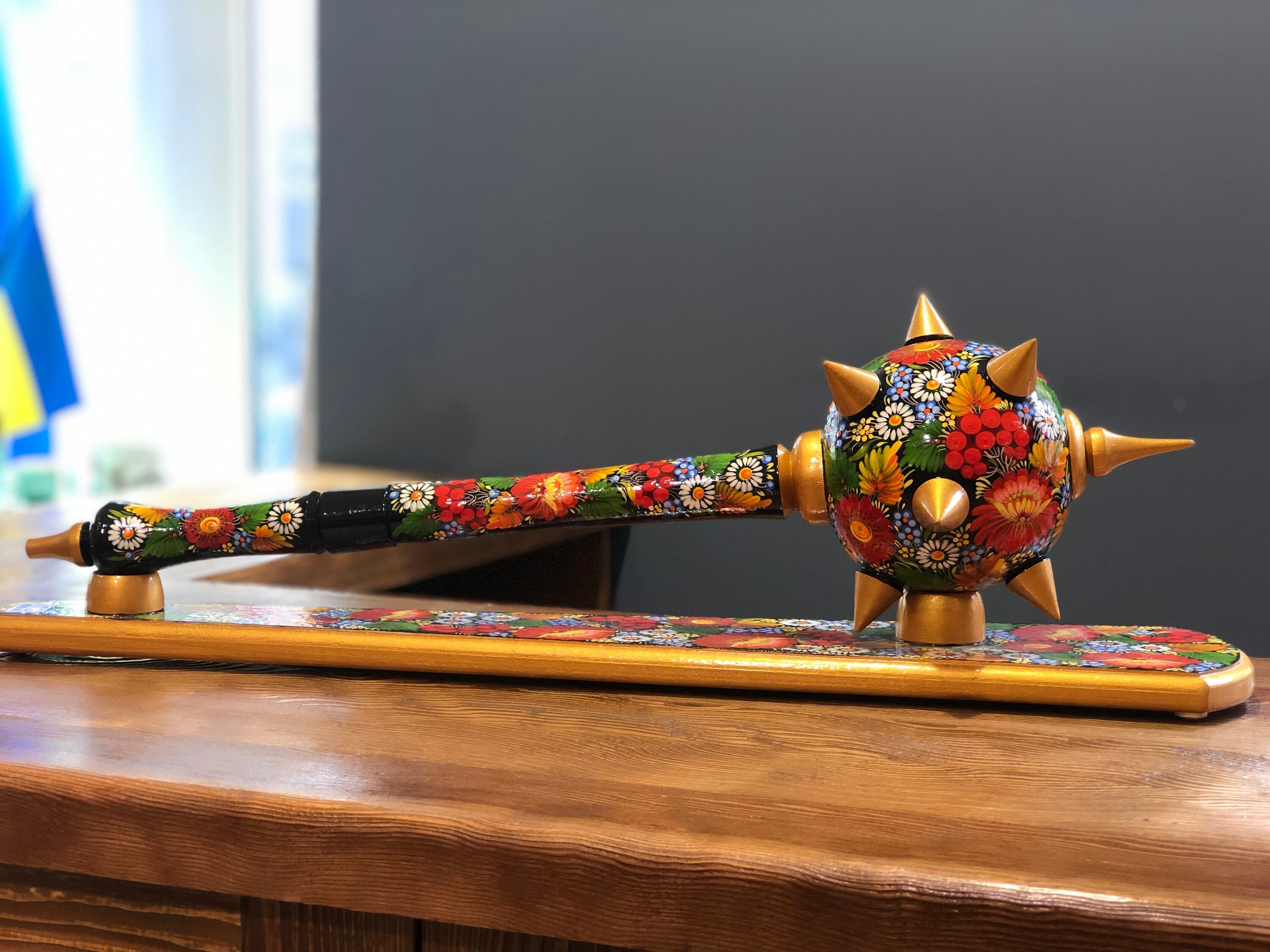 Handmade wooden Ukrainian Bulava, decorated with vibrant floral patterns, traditional mace souvenir for men valuing history and culture.