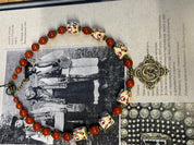 Handmade Ukrainian necklace with white clay and jasper beads on embroidered fabric, showcasing traditional craftsmanship.
