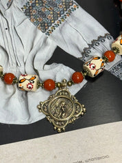 Ukrainian handmade necklace with white clay and jasper beads, featuring traditional designs and cultural symbols.