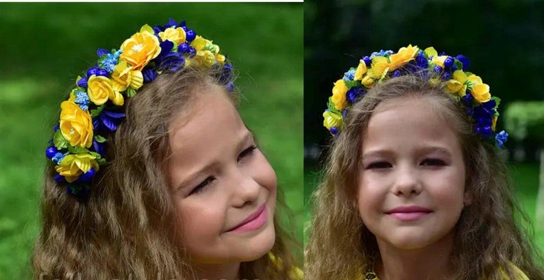 Girl wearing floral wreath with blue and yellow flowers, smiling outdoors