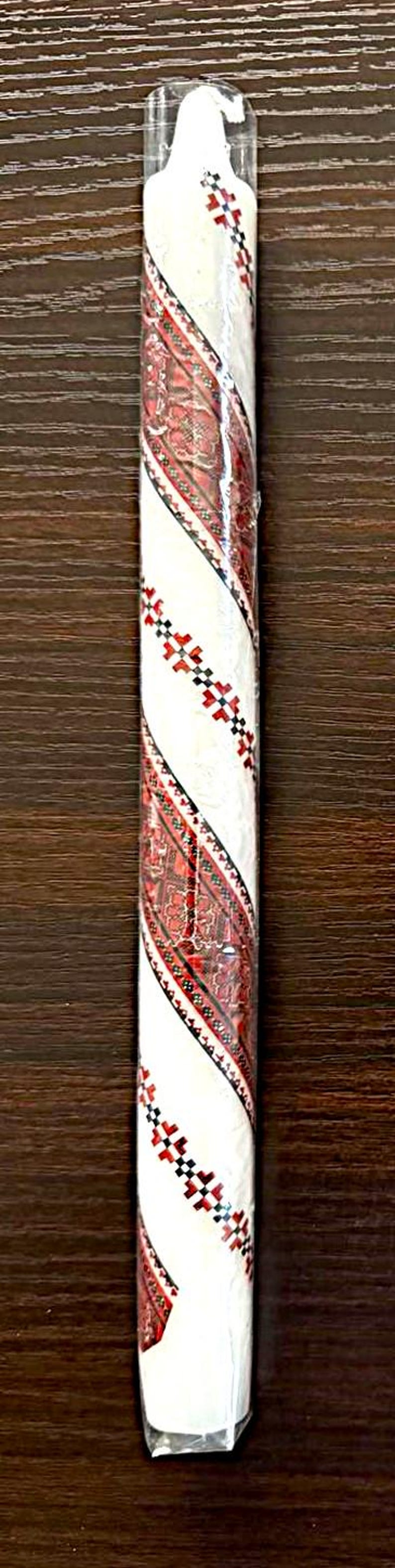 Handmade Ukrainian holiday taper candle with traditional red and white patterns, perfect for festive Christmas or Easter decor.