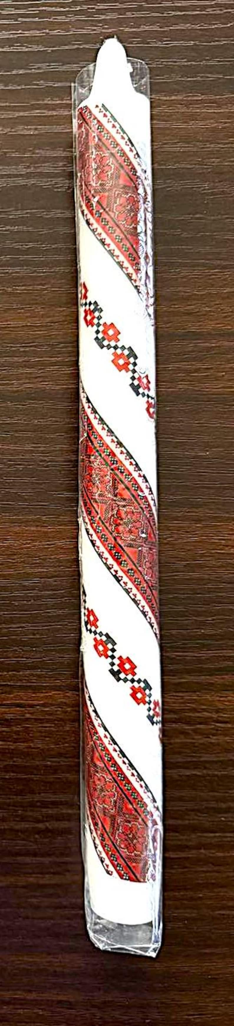 Handmade Ukrainian taper candle with traditional red and black patterns, perfect for Christmas or Easter festive decor.