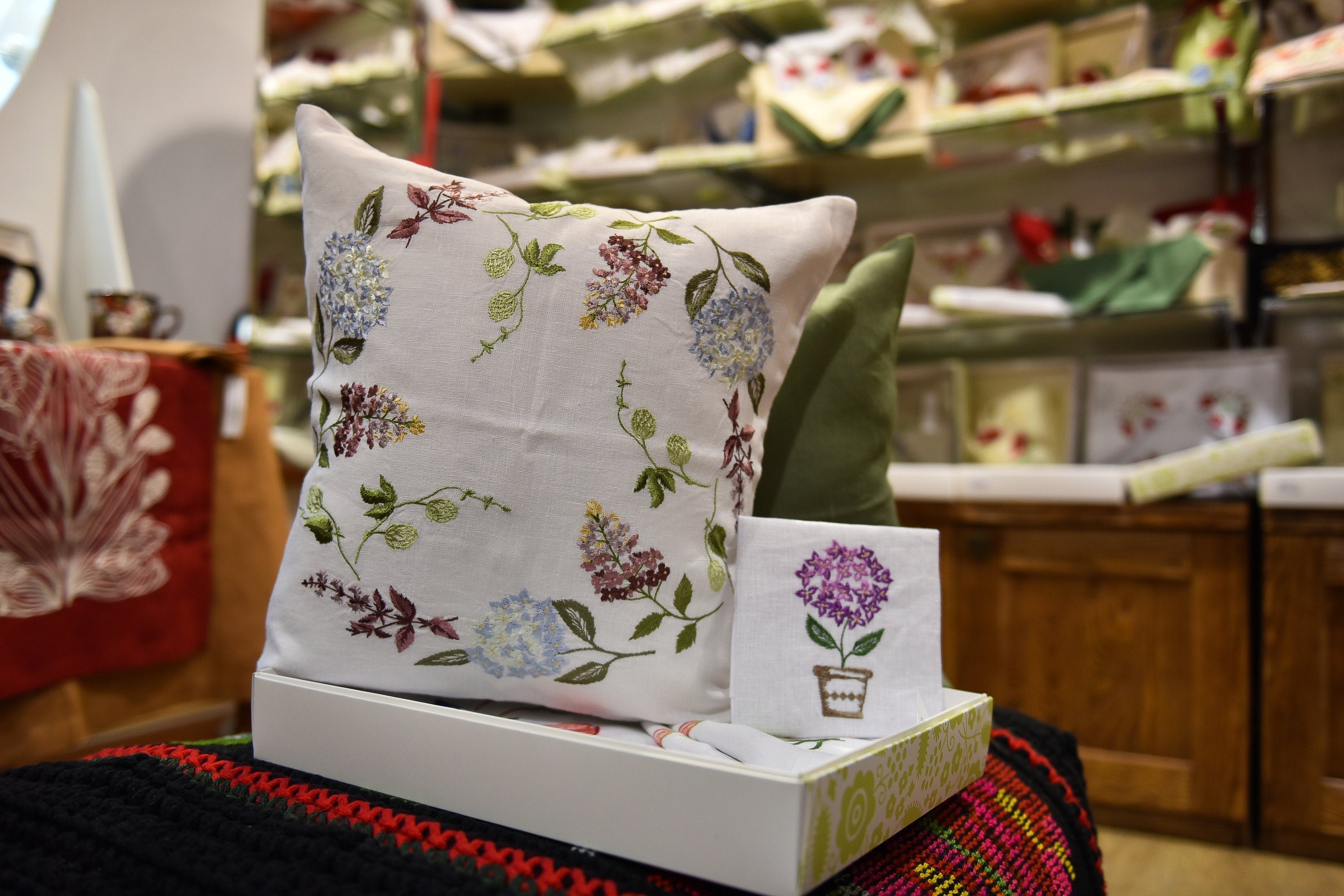 Embroidered linen pillowcase with floral design, 40x40 cm, displayed in a cozy setting, perfect for Easter or Mother's Day gift.