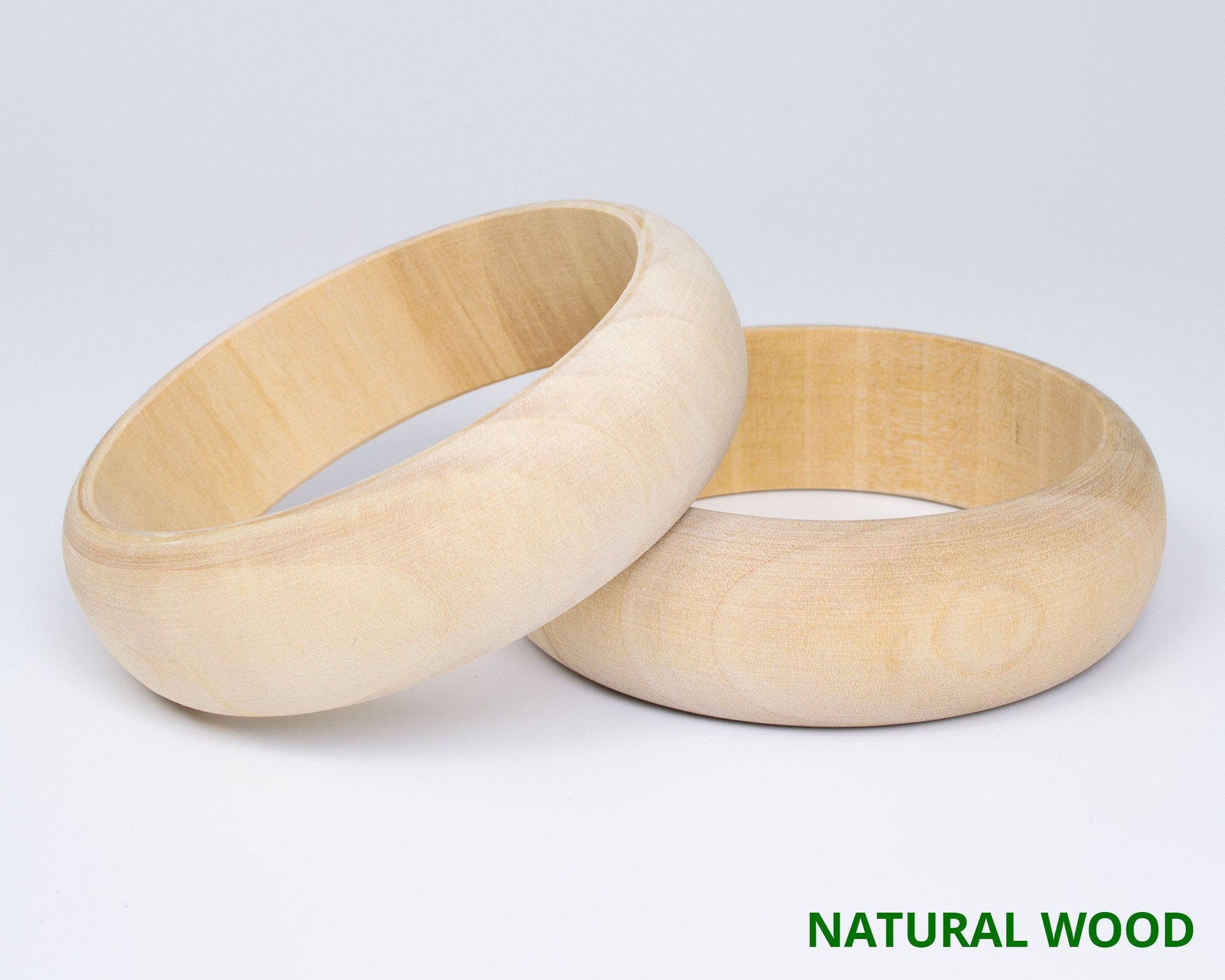 Natural wood bangles, ready for hand-painted Petrykivka floral designs, showcasing traditional Ukrainian artistry.