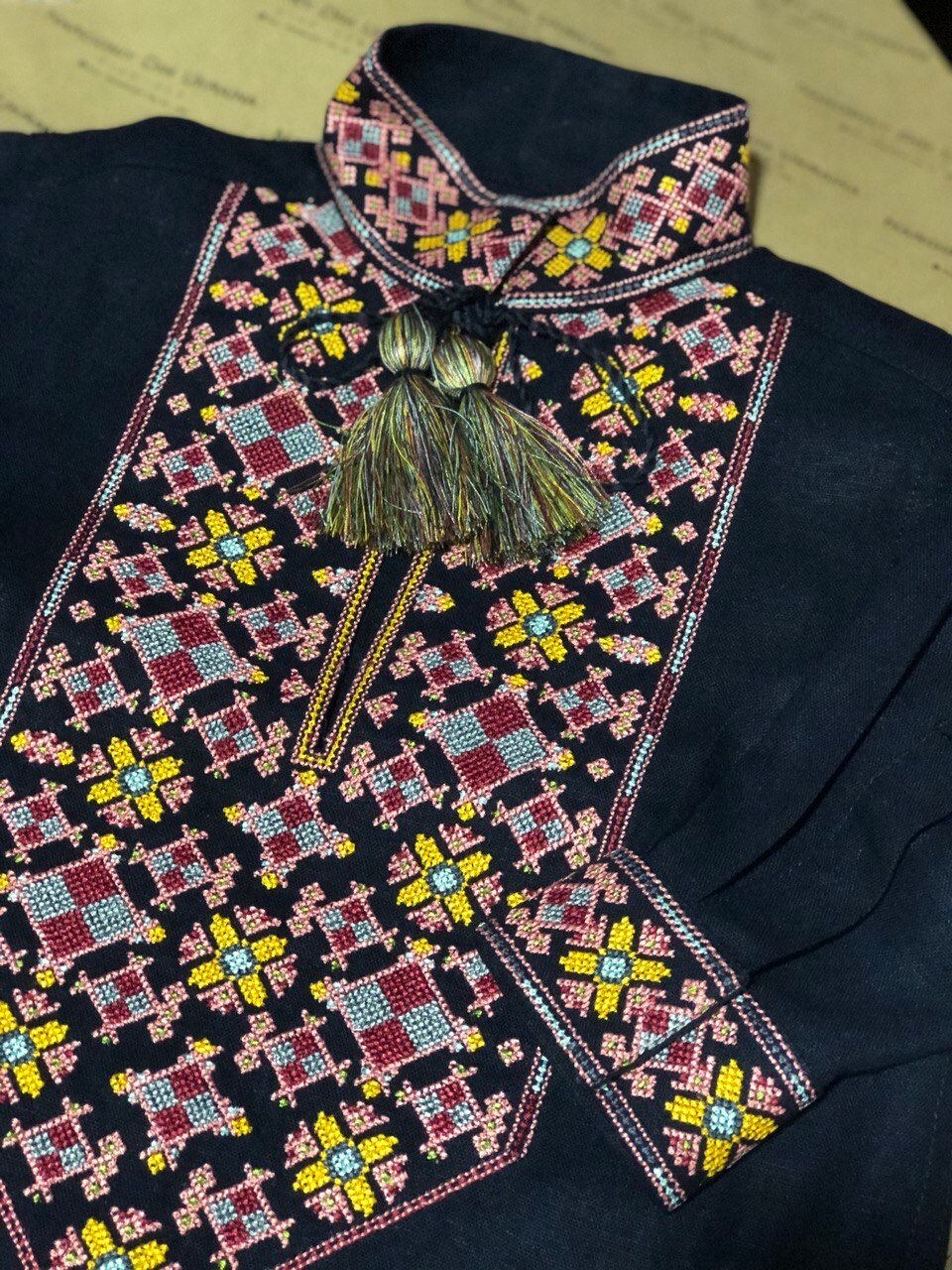 Traditional Ukrainian vyshyvanka with colorful embroidery on dark linen fabric.