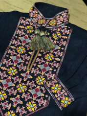 Traditional Ukrainian vyshyvanka with colorful embroidery on dark linen fabric.