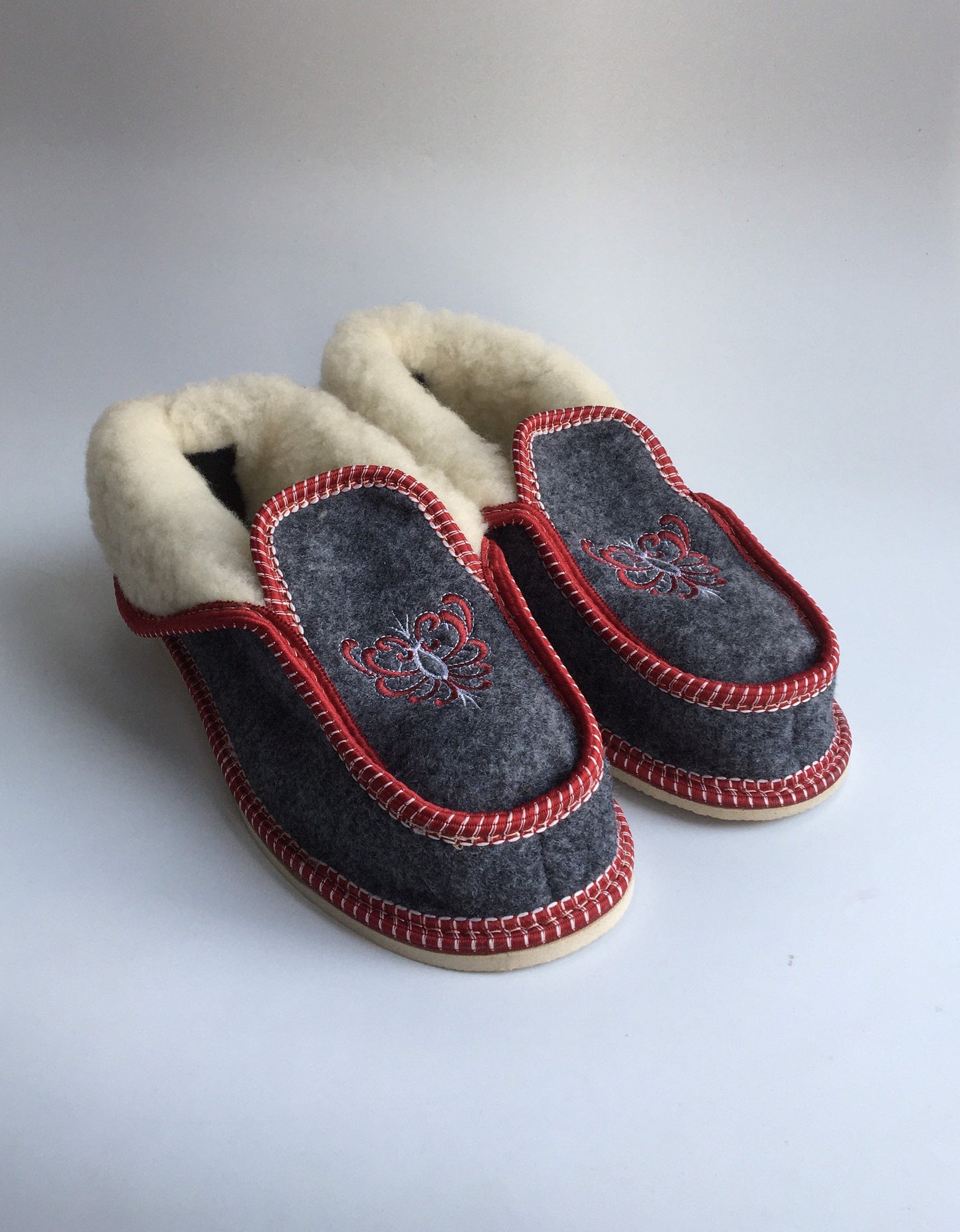 Handmade Carpathian wool slippers with Hutsul embroidery, cozy and stylish, perfect Ukrainian Christmas gift.