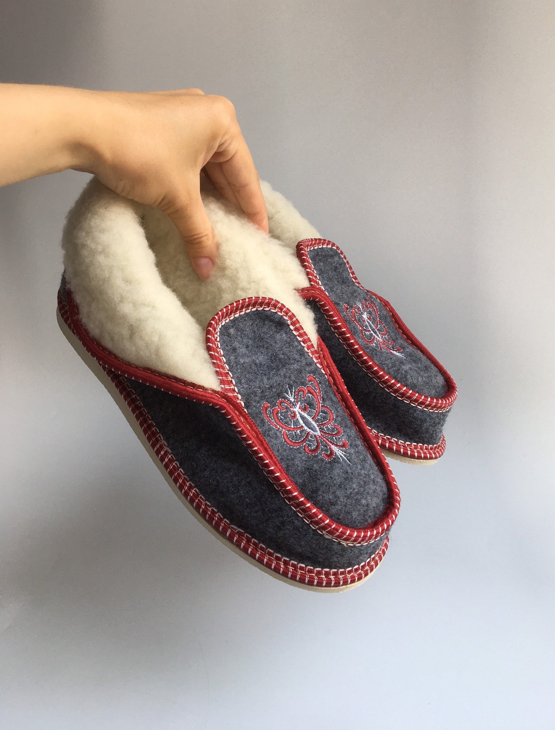 Handmade Carpathian wool slippers with vibrant Hutsul embroidery, cozy Ukrainian gift.