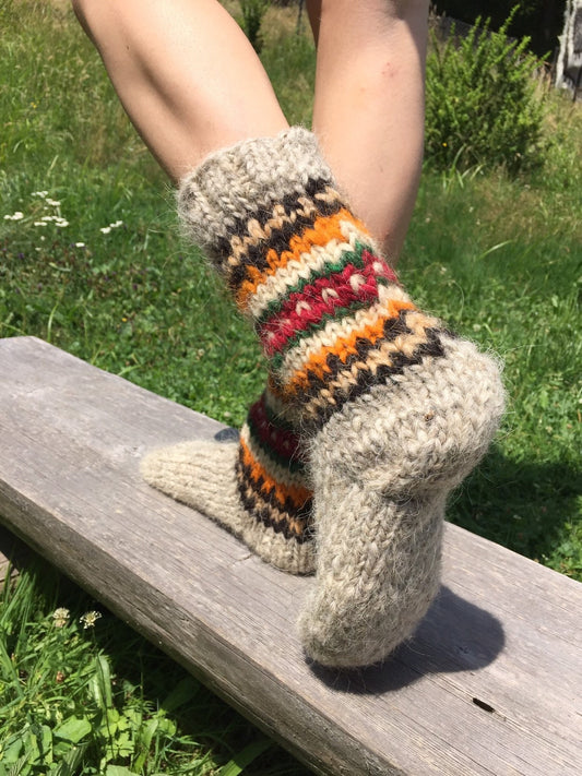 Handmade wool socks from Ukraine featuring colorful patterns, perfect for warmth and natural foot massage.