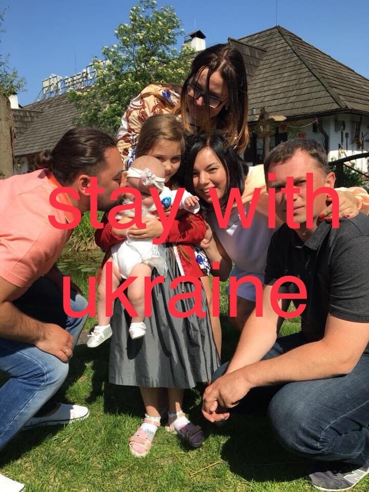 Family gathering outdoors with "stay with Ukraine" message overlaid.