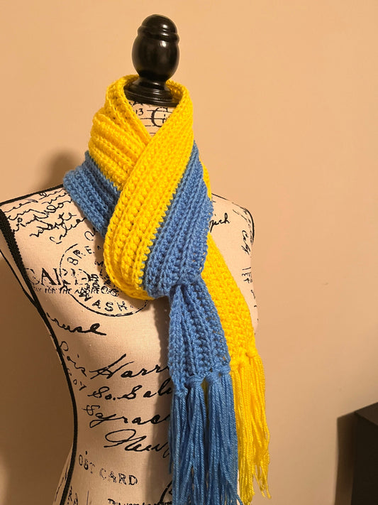 Handmade blue and yellow crochet scarf inspired by Ukrainian flag on mannequin, cozy winter fashion accessory.