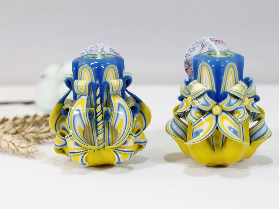 Handcrafted blue and yellow carved candles, "Stand with Ukraine" design, symbolizing hope and unity.