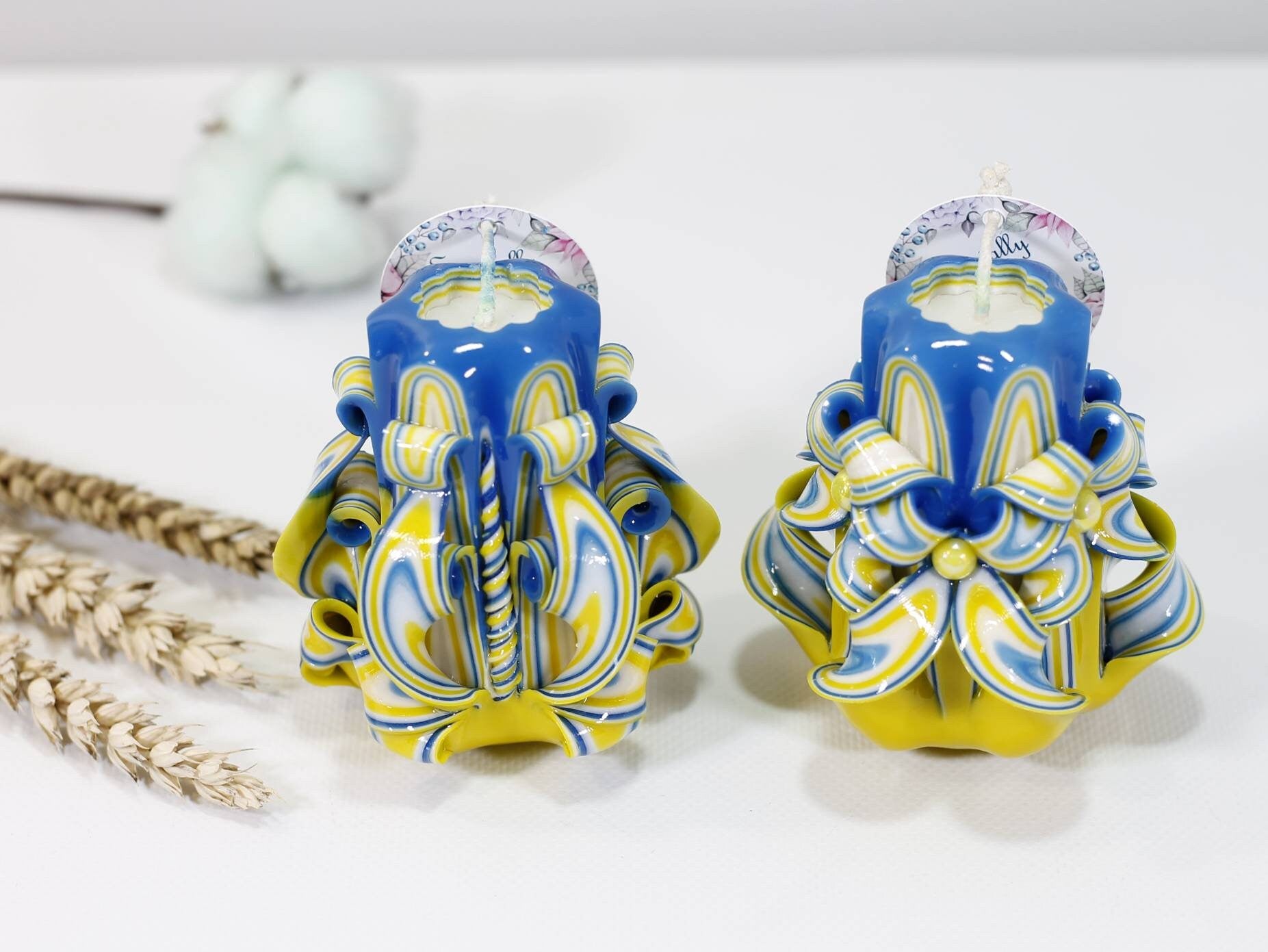 Handcrafted blue and yellow carved candles symbolizing support for Ukraine, reflecting hope and unity.