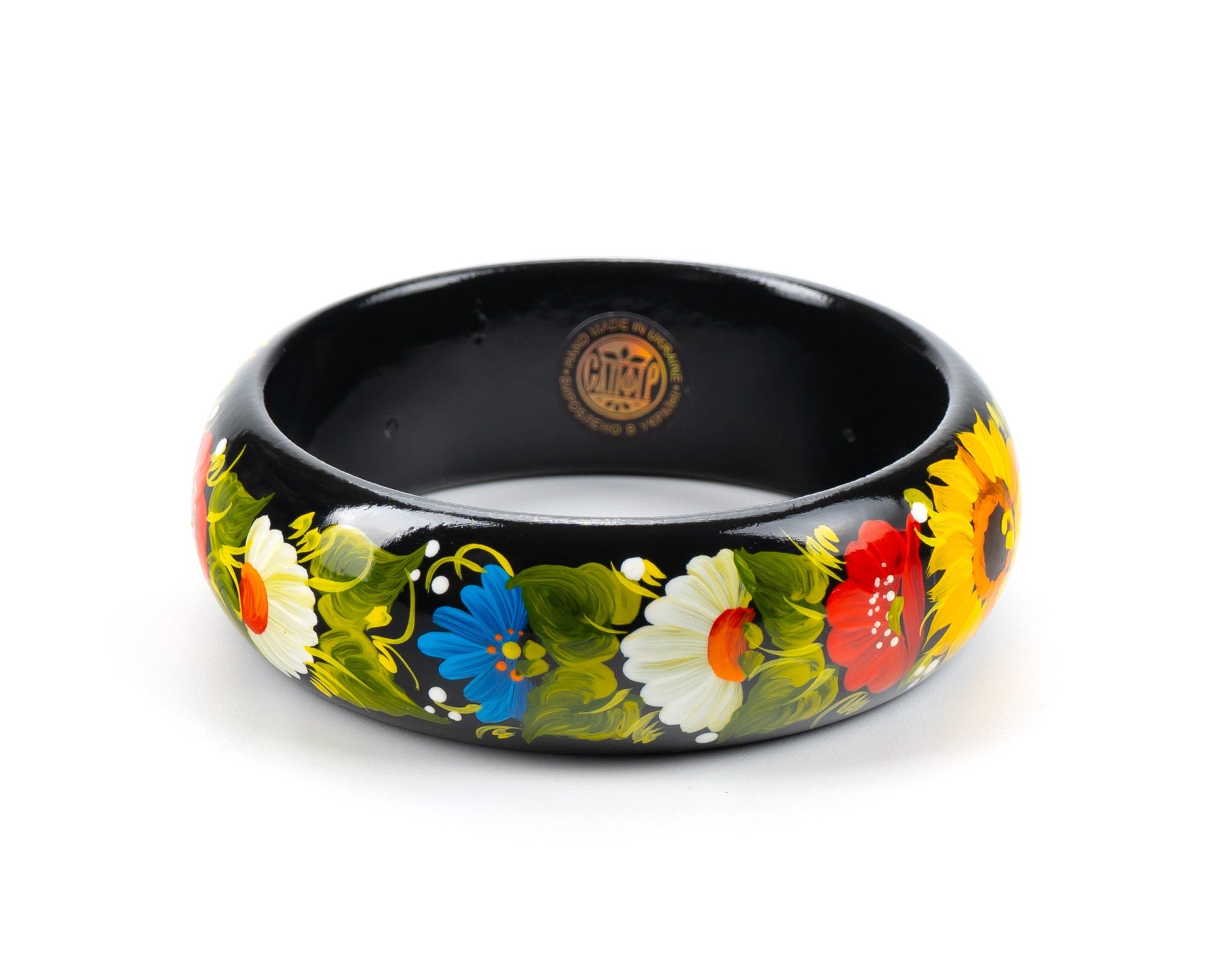 Hand-painted Petrykivka wooden bangle with vibrant floral designs, including asters and chamomile, on black background. Unique Ukrainian bracelet.