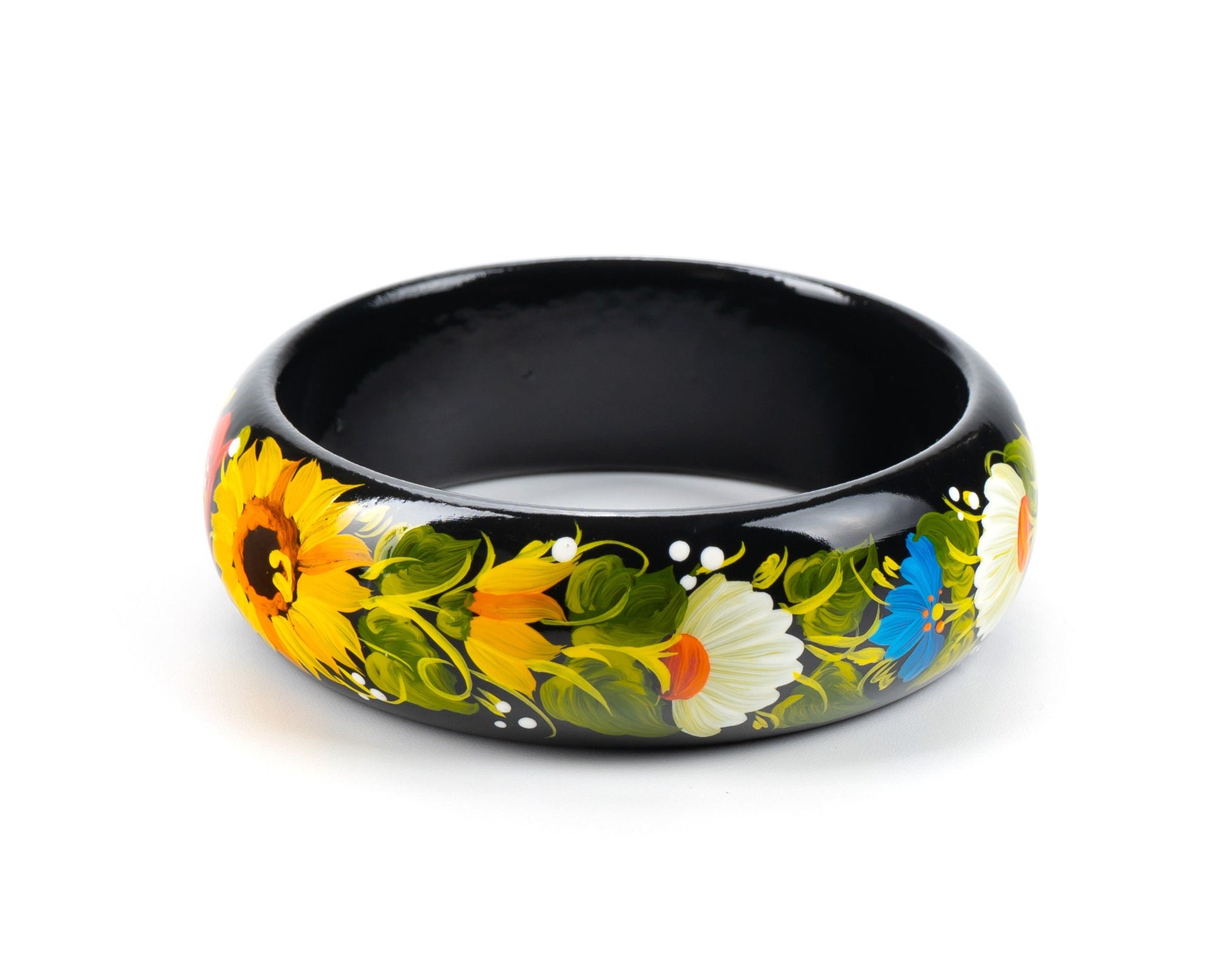 Hand-painted Petrykivka wooden bangle with vibrant floral design, including sunflowers, on a black background. Unique Ukrainian jewelry.