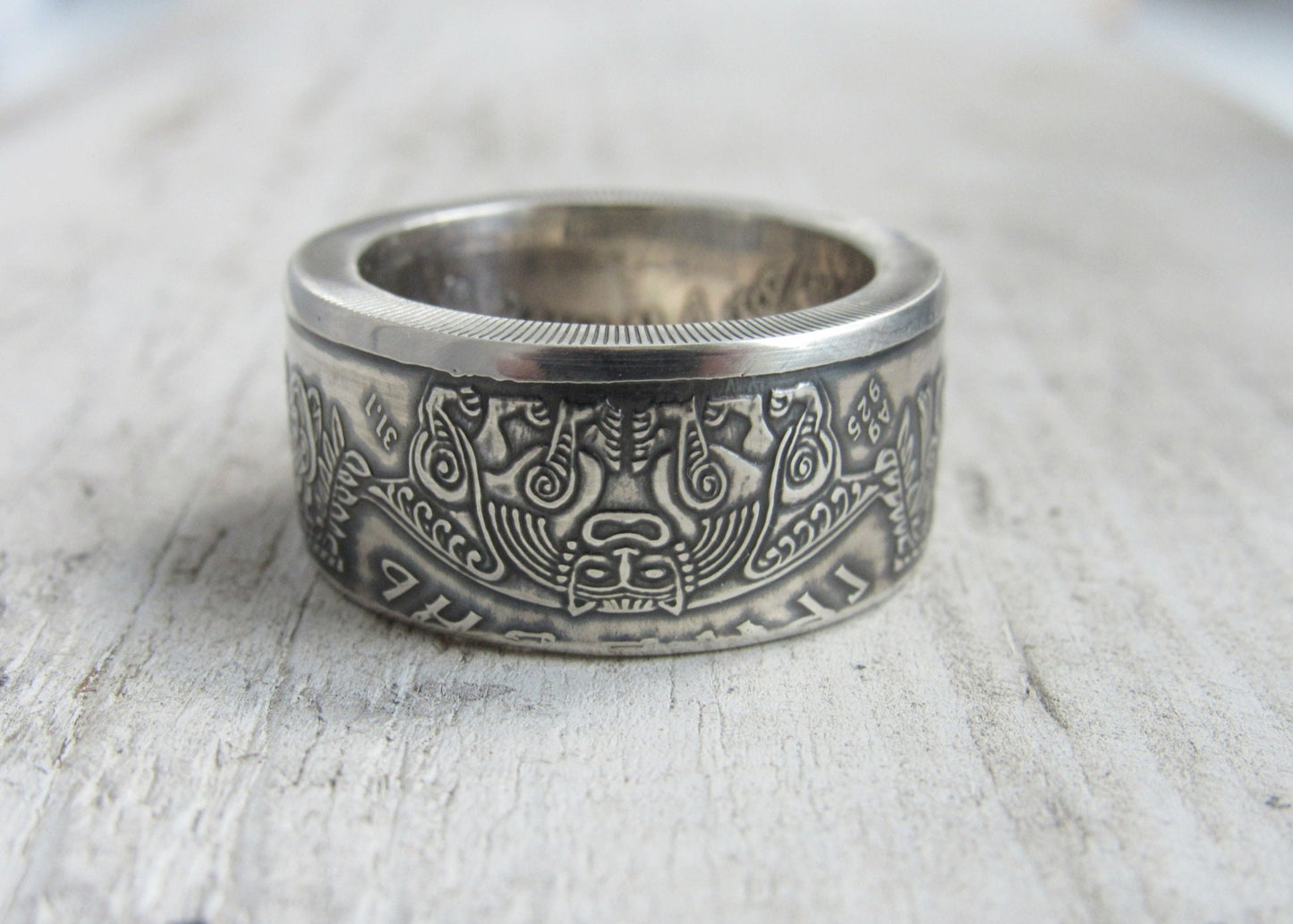 Handcrafted silver ring from 1999 Ukrainian coin featuring Kyivan Rus Prince Askold design on rustic surface