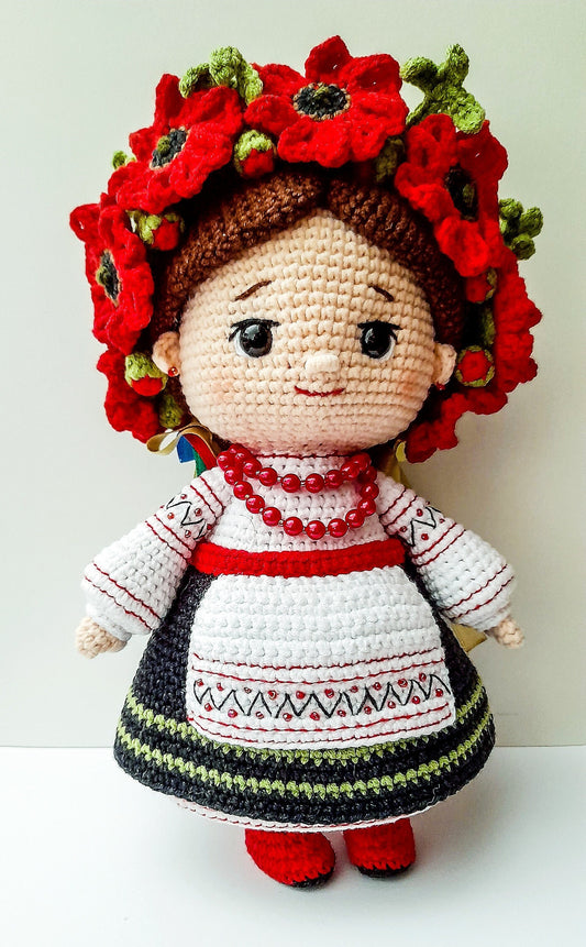 Handmade crochet Ukrainian doll in traditional attire with red flowers, a unique souvenir gift.