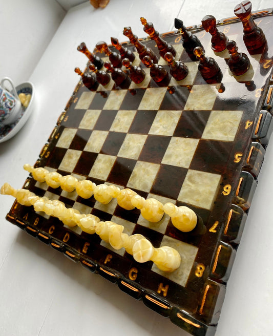 Handcrafted Baltic amber chess set on elegant board, perfect for collectors and enthusiasts.