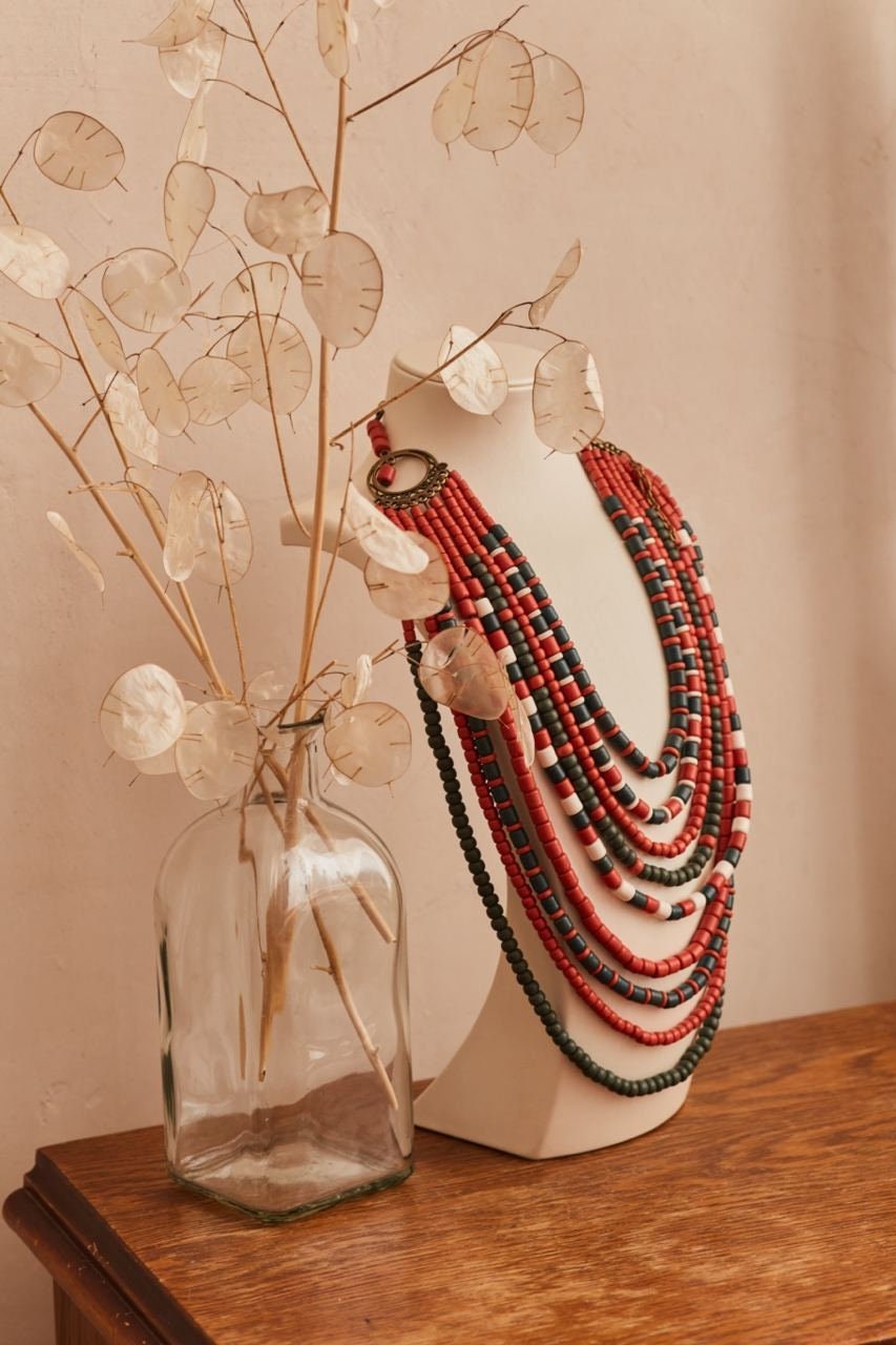 Handmade red and green Ukrainian ceramic necklace displayed on bust, ethnic jewelry perfect as traditional Easter gift for her.