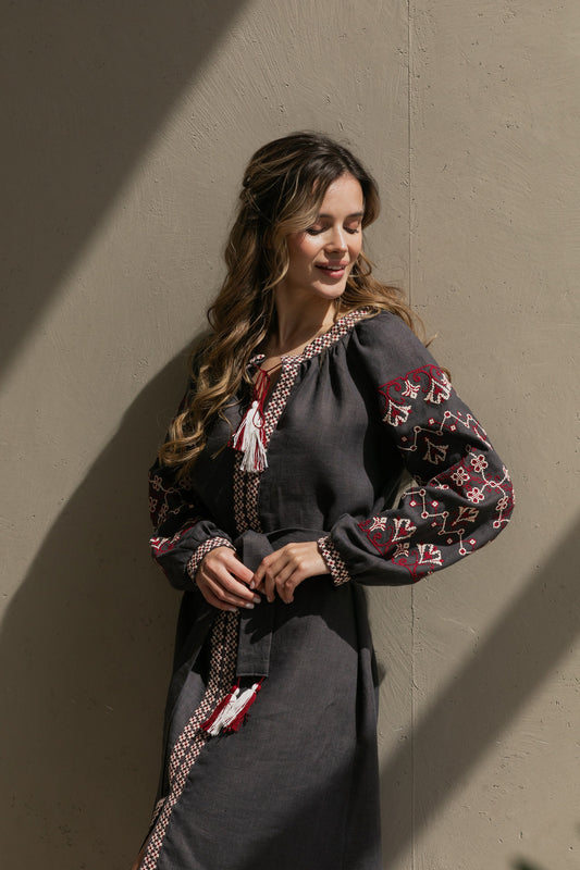 Woman wearing a gray linen Vyshyvanka dress with colorful embroidery, capturing Ukrainian boho folk style.