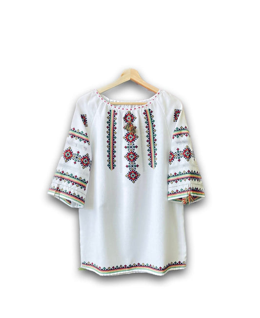 Handmade Ukrainian Vyshyvanka blouse with traditional cross-stitch embroidery, perfect for a boho fashion statement.