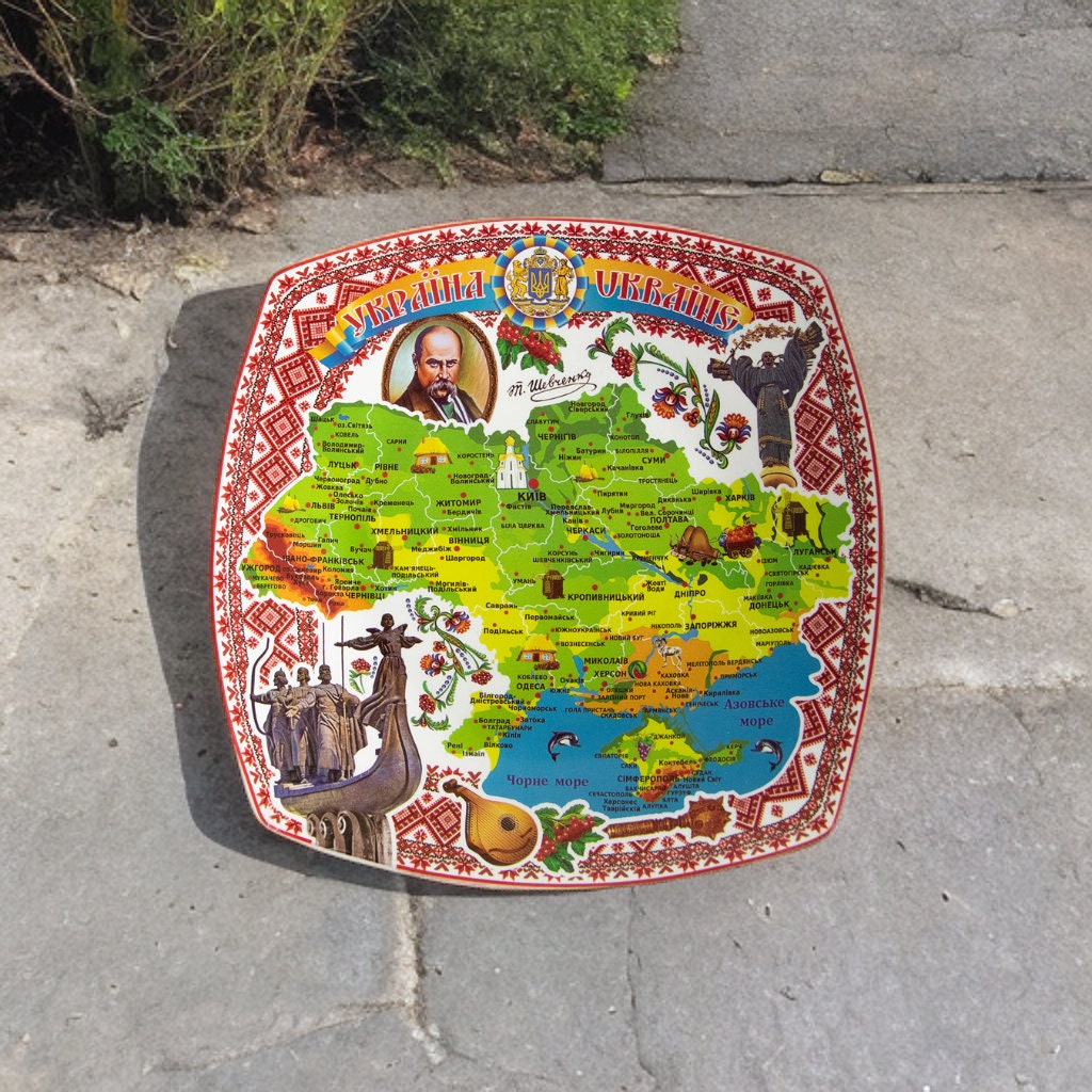 Ukrainian souvenir plate with map and Taras Shevchenko portrait, handmade ceramic decoration for home display.