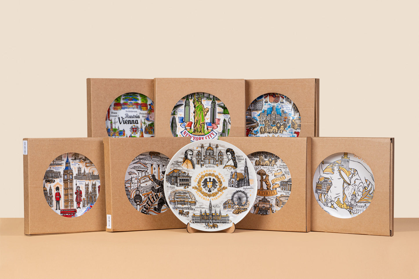 Decorative souvenir plates featuring cityscapes and landmarks, displayed in cardboard packaging.