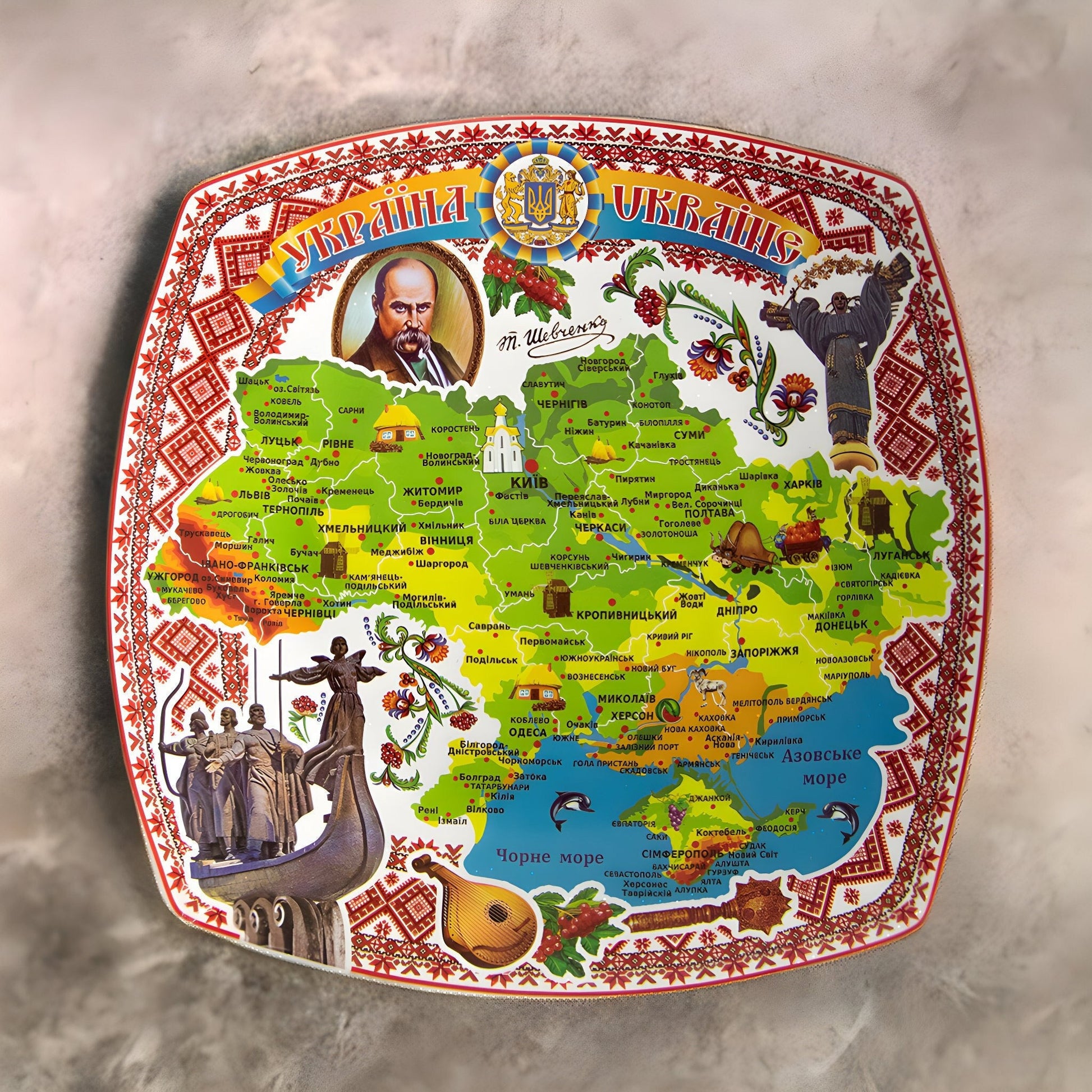 Ukrainian souvenir plate with map decal and Taras Shevchenko tribute, vibrant decorations, handmade ceramic art for home decor.