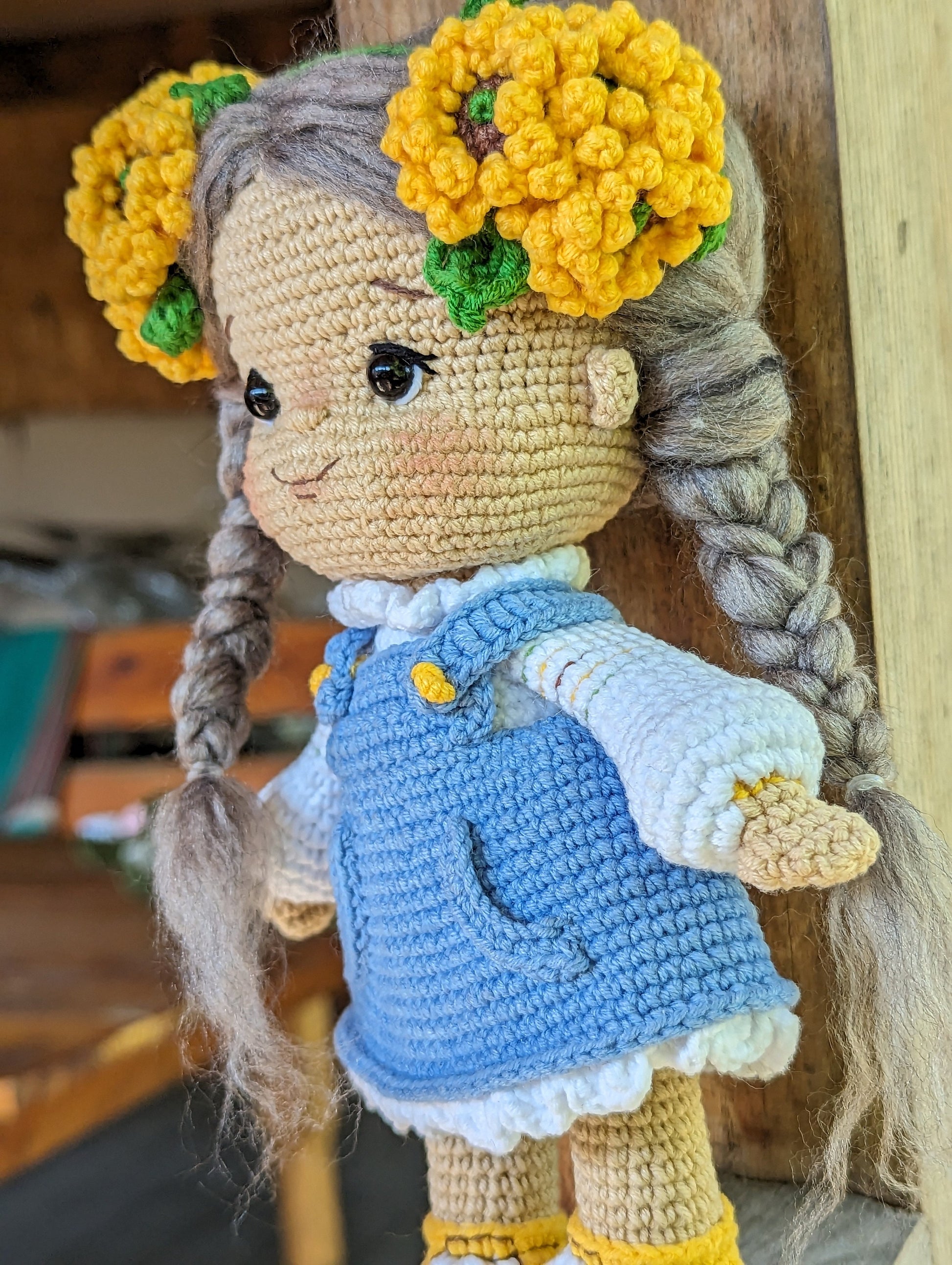 Handmade crochet Ukrainian doll in folk-style outfit with braided hair and floral headband.