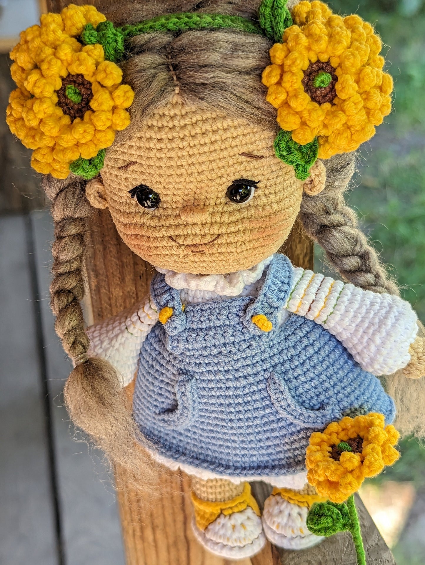 Handmade crochet Ukrainian doll with yellow flowers, dressed in blue folk-style attire, perfect for gifts and nursery decor.