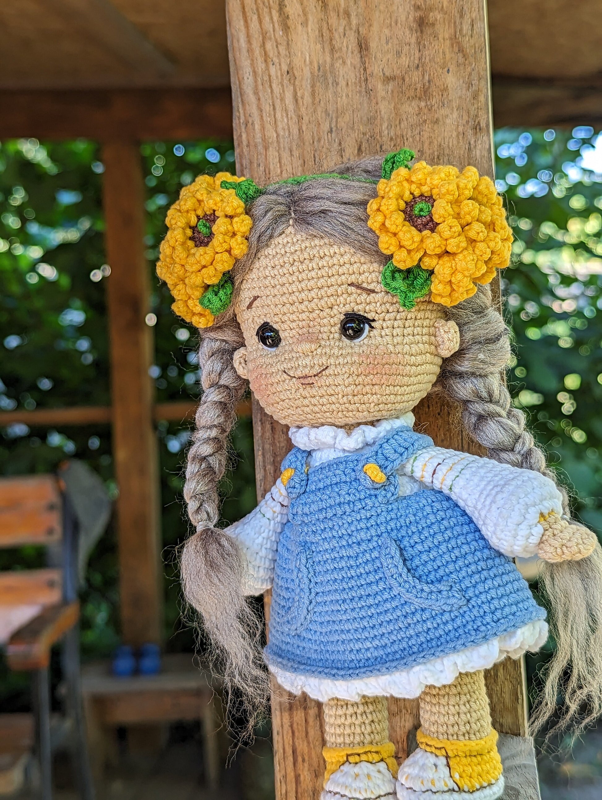 Handmade crochet Ukrainian doll with flowers in hair, wearing a blue dress, perfect cultural souvenir and gift for children.