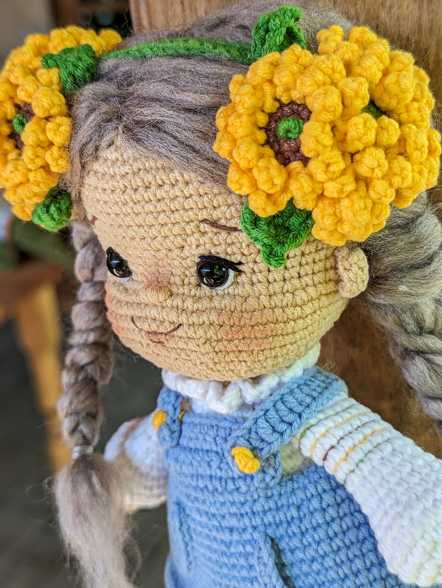 Handmade crochet Ukrainian doll with folk-style design and yellow flower accessories, perfect cultural gift or nursery decor.