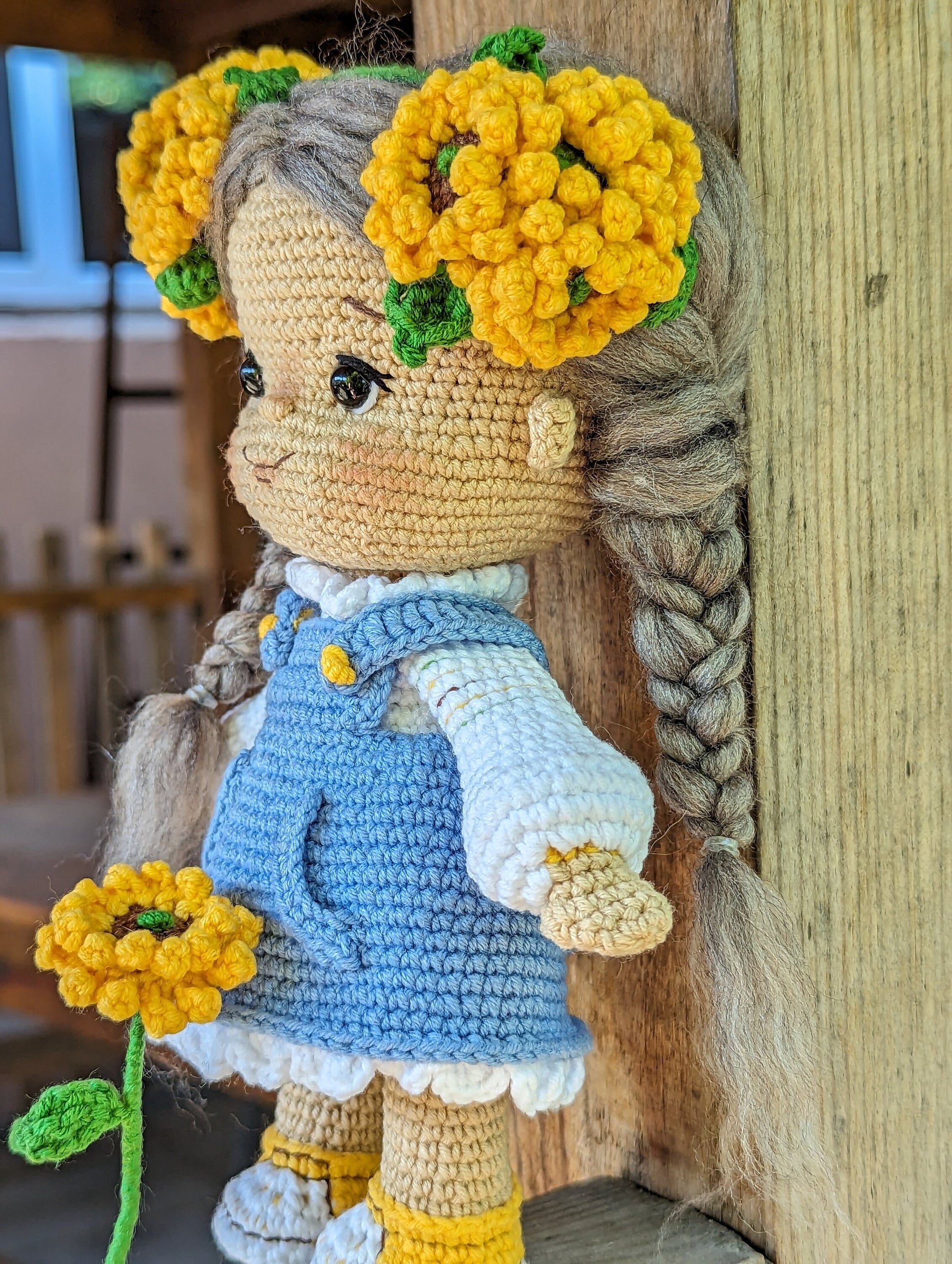 Handmade crochet Ukrainian doll in folk-style attire with yellow flower accessories, perfect souvenir or gift for children.