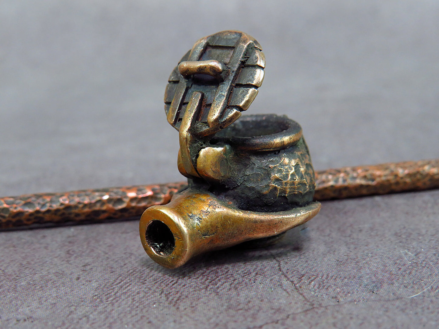 Handcrafted bronze smoking pipe with Ukrainian trident, unique artisan souvenir, memorable gift for smokers, cultural design.