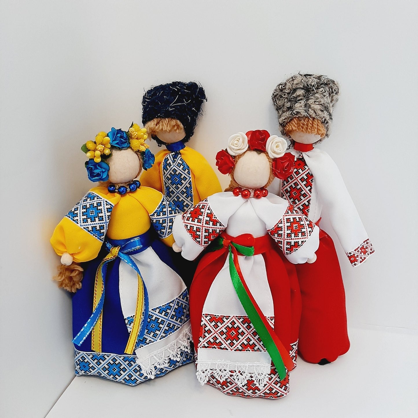 Handcrafted Ukrainian folk dolls in traditional clothing, featuring vibrant embroidery, symbolic of cultural heritage.