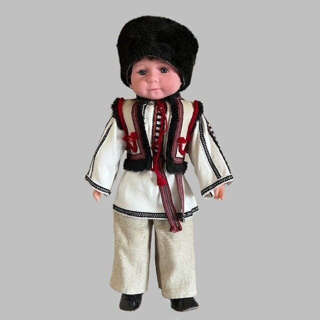 Ukrainian boy doll Vasyl in traditional Carpathian attire with hand-embroidered details and black fur headpiece.