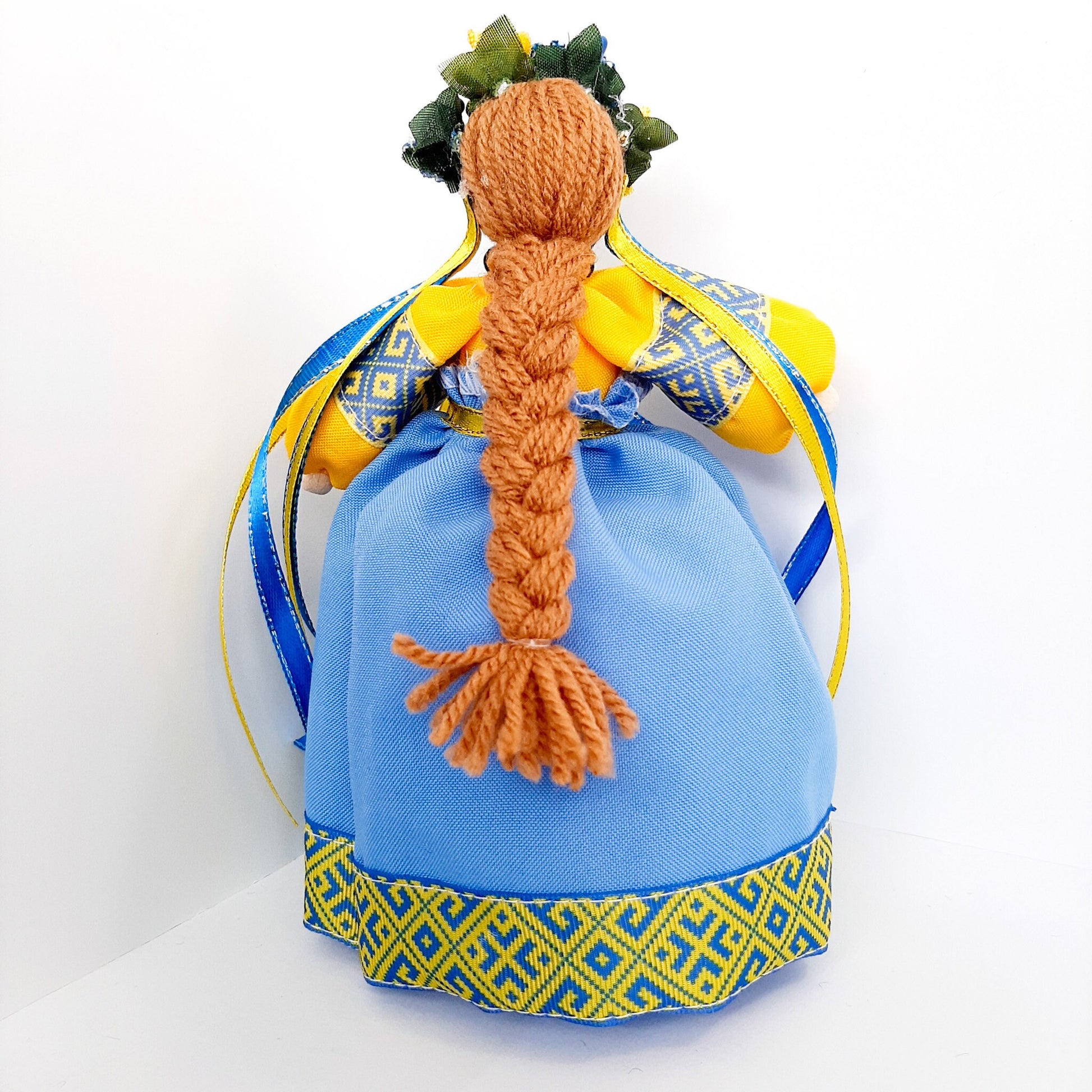 Handmade Ukrainian Motanka Doll with blue dress and braided hair, traditional housewarming amulet symbolizing peace and protection.