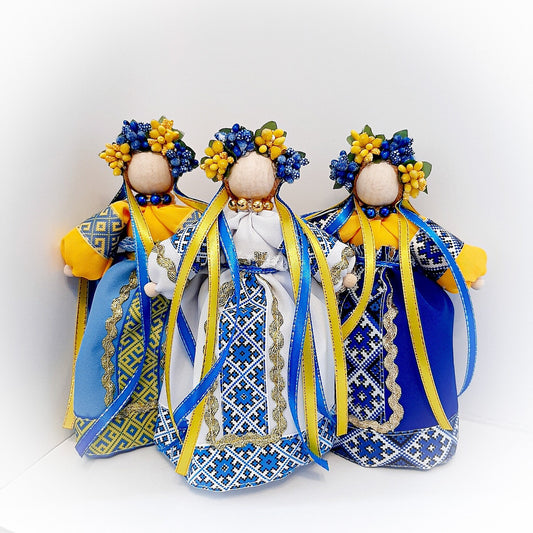 Ukrainian Motanka dolls with traditional attire and floral crowns, symbolizing home protection and prosperity, perfect housewarming gift.