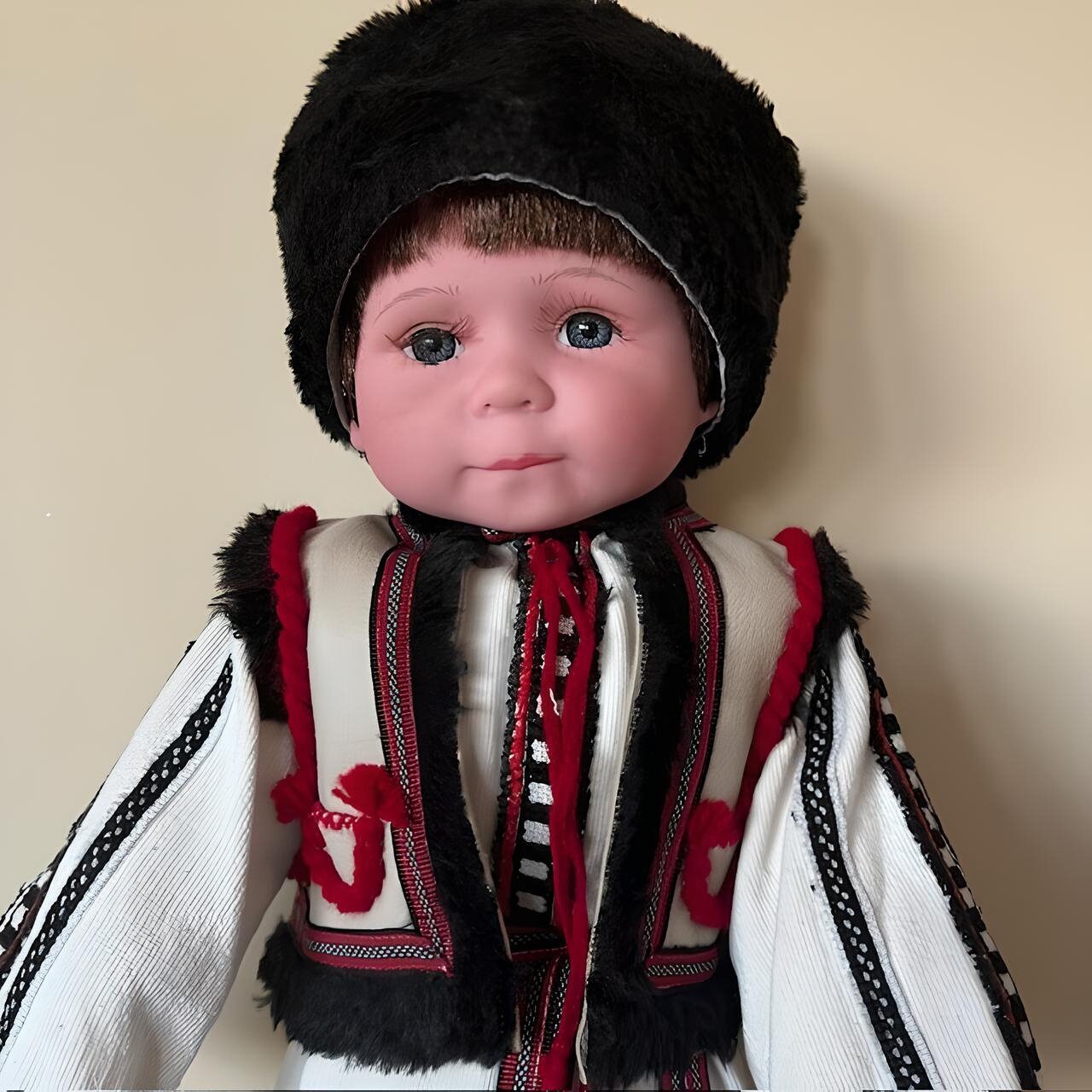 Handmade Ukrainian boy doll Vasyl in traditional Carpathian outfit with embroidered details and black fur headpiece.